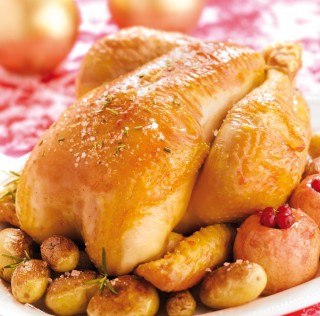 Roast Label Rouge traditional capon with baked apples and potatoes