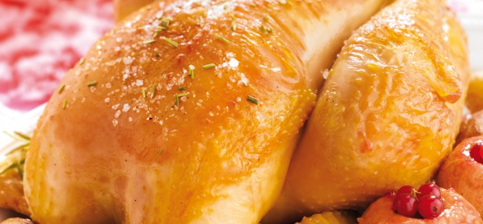 Roast Label Rouge traditional capon with baked apples and potatoes